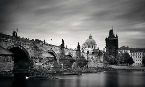 Prague skyline and bridge over river in Czech Republic.